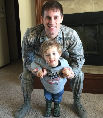 Dr. Stines in military uniform and with kid
