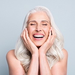  An older woman enjoying her new dental implants