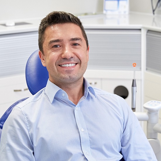 man smiling in exam chair