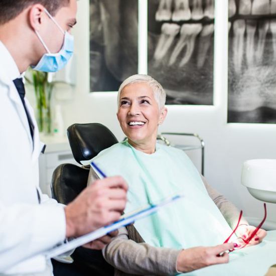 a patient smiling while visiting her dentist