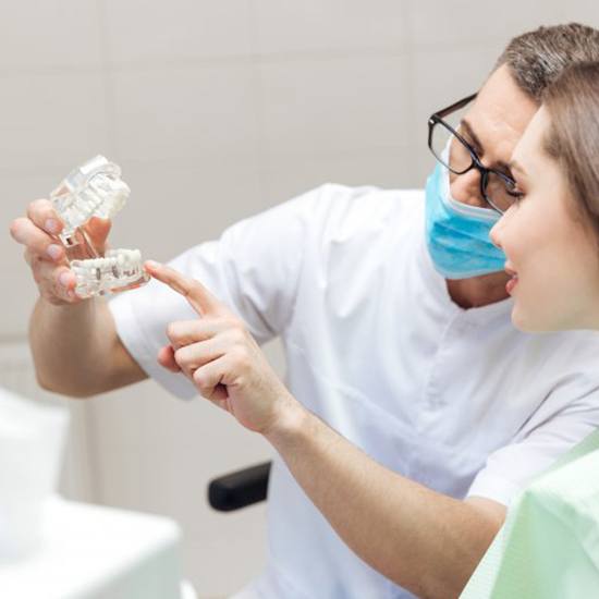 a dentist explaining dental implants to a patient