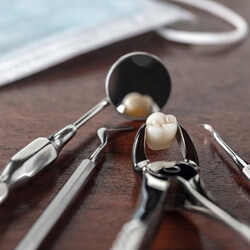 an extracted tooth on a table with dental tools