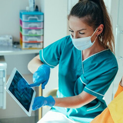 a dentist showing a patient their dental X-ray