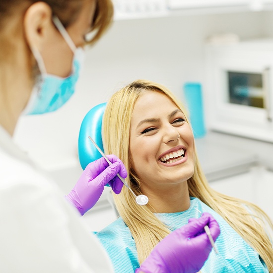 woman laughing in exam chair