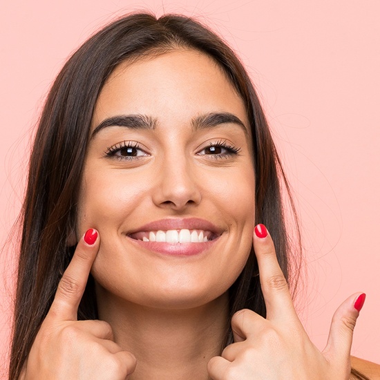 woman pointing to white smile