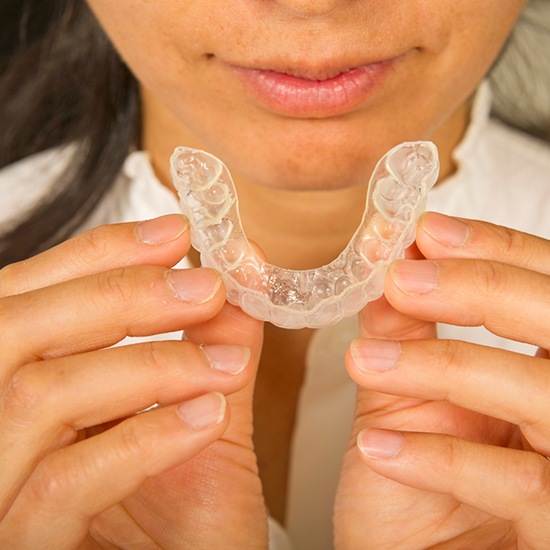 woman holding invisalign tray