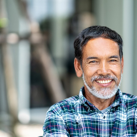 Man smiling with dental crown in Grand Island