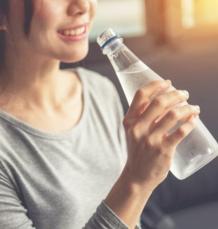 Woman holding bottle of water