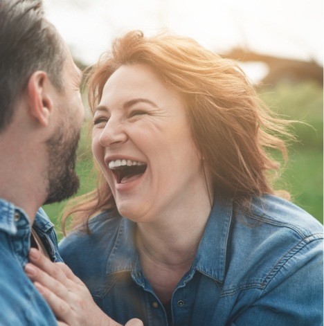 man and woman laughing and smiling