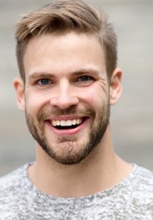 man smiling while outside 