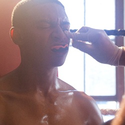 Man holding a mouthguard in his mouth