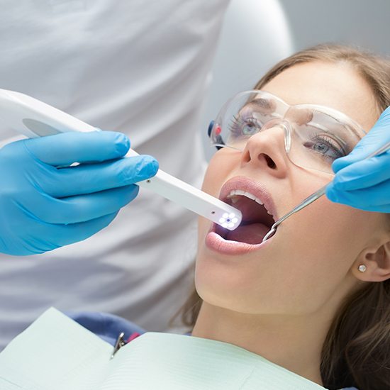 woman having oral cancer screening done