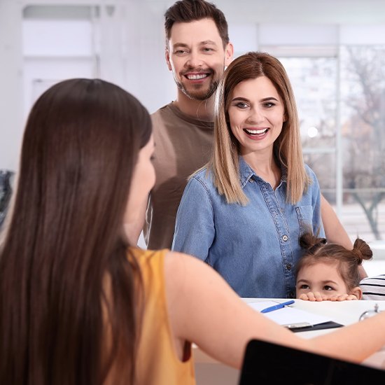 family of three at front desk