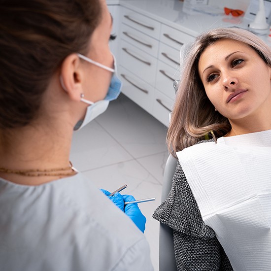 Patient in Grand Island talking to dentist about dental implant failure