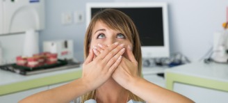 woman covering mouth with hands