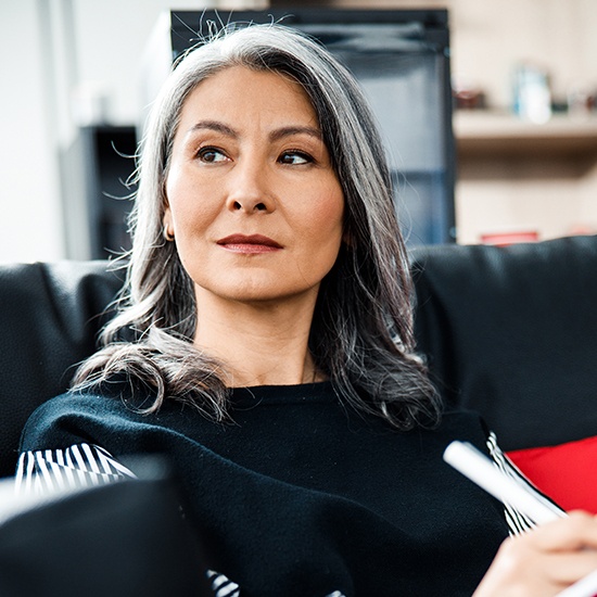 woman sitting on black couch