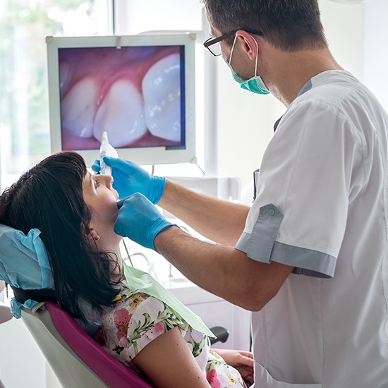 dentist using intraoral camera