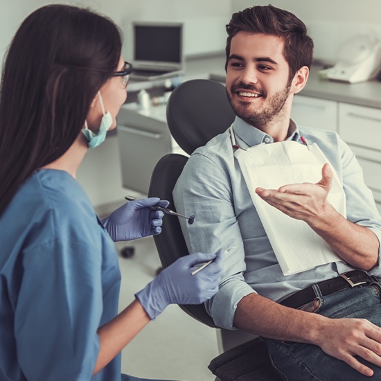 young man talking to dentist