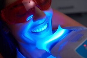 Facial zoom in of woman having teeth whitened by dentist