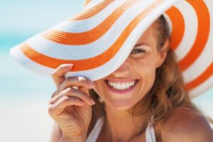 a person smiling while visiting the beach 