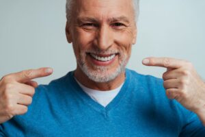 Man smiling while wearing his dentures